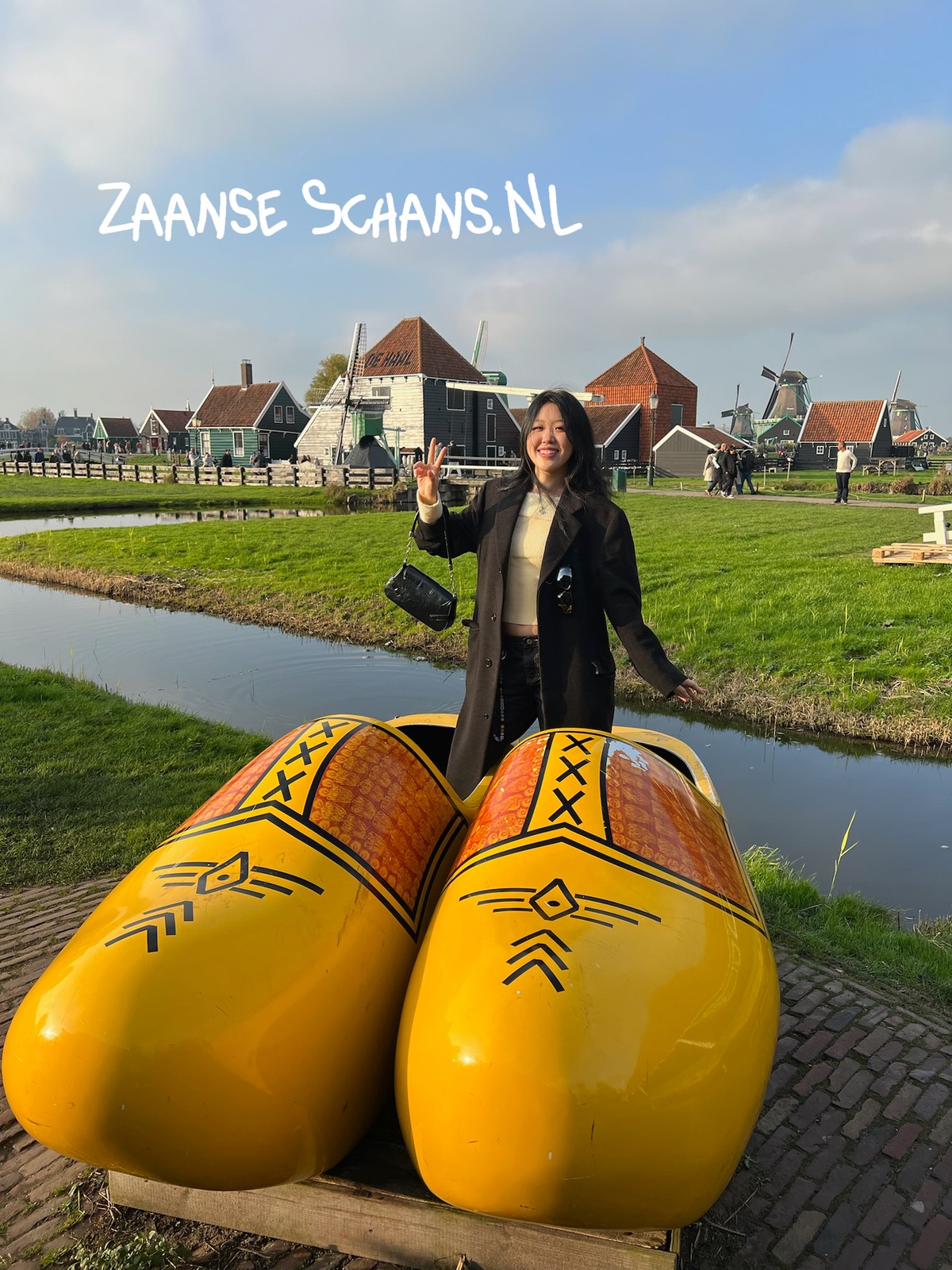 Cherry next to giant wooden clogs at Zaanse Schans, Netherlands