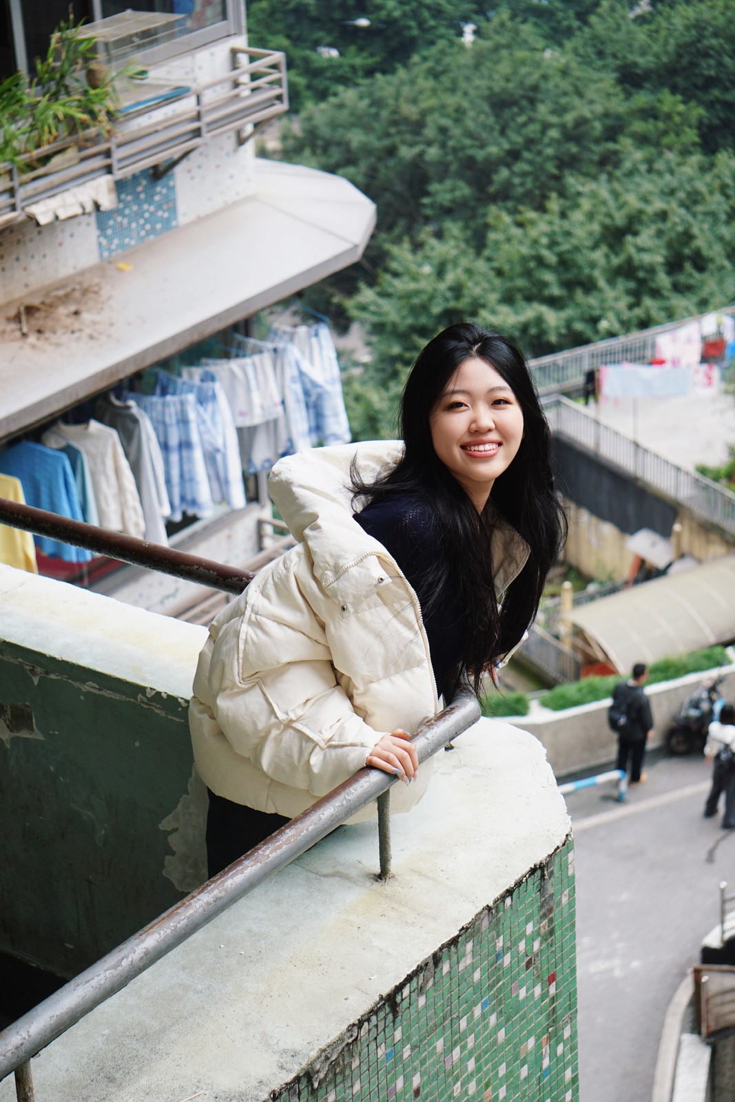 Cherry leaning on a balcony rail in Chongqing