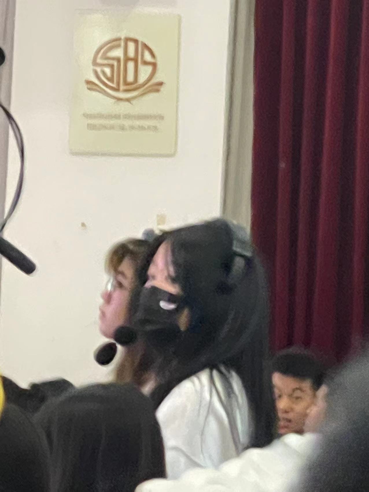 Cherry wearing a headset during a media production