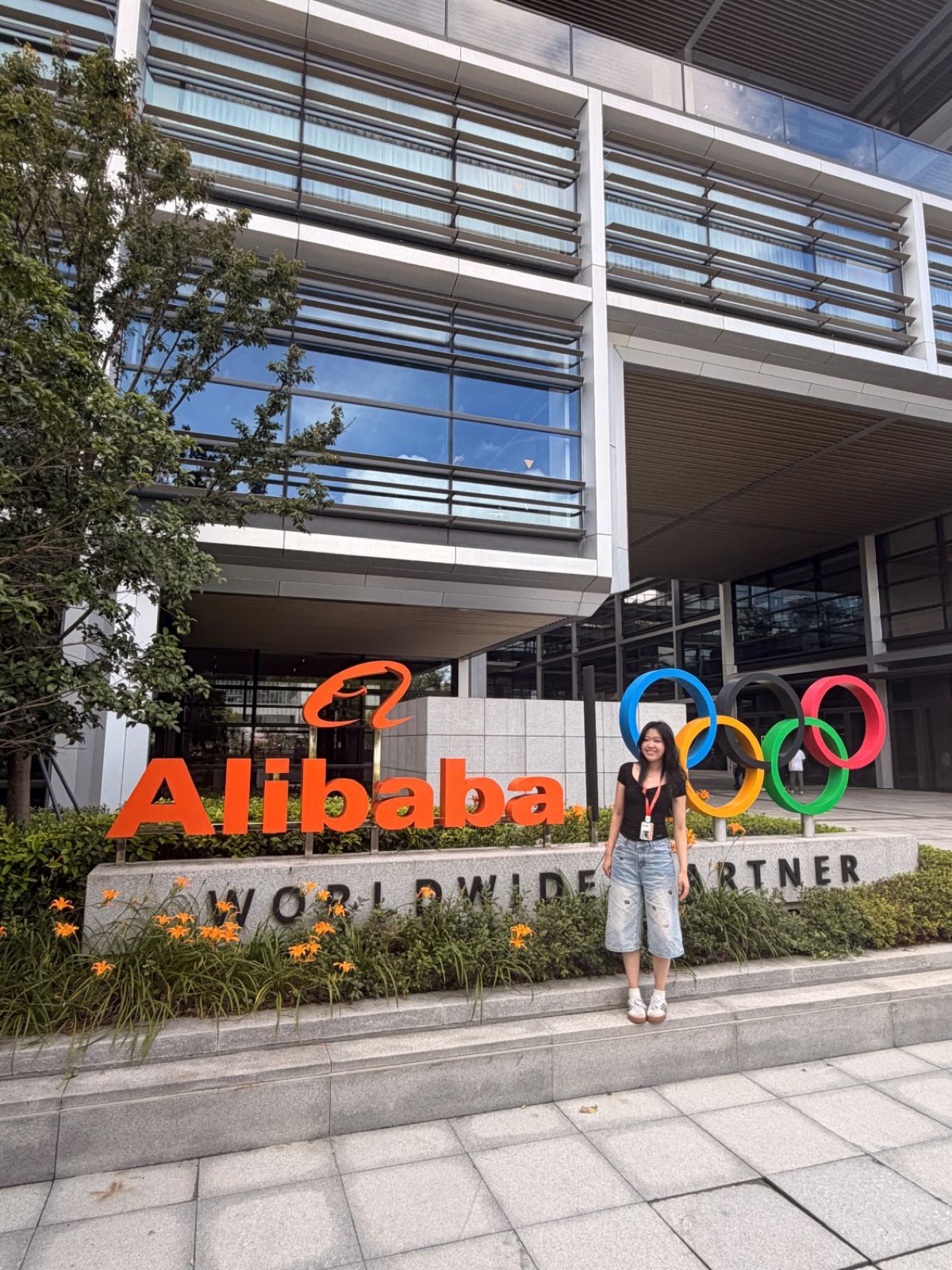 Cherry in front of the Alibaba sign at the office