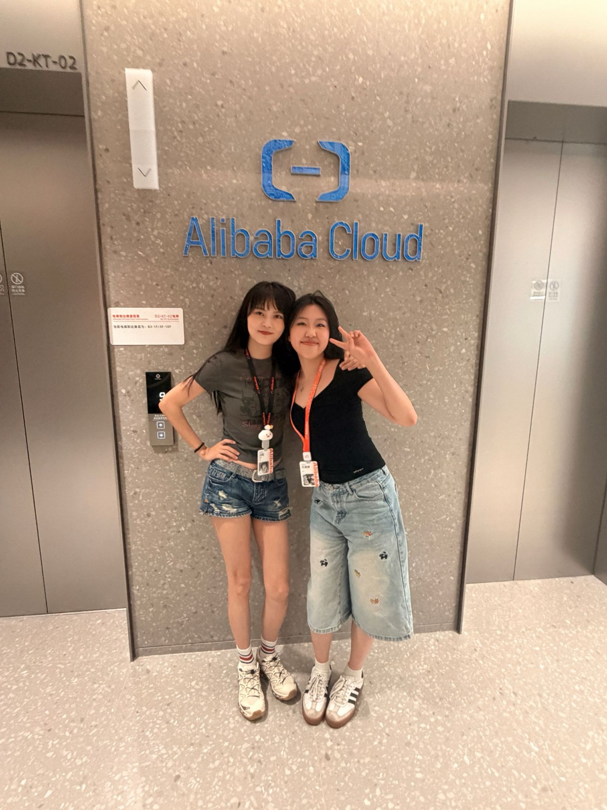 Cherry and her mentor in front of the Alibaba Cloud sign